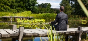 business man on dock meditating